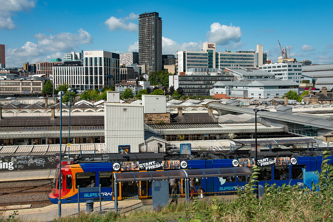 Sheffield Railway station seen from the east with Supertram stop in foreground and city centre behind, Granville Street, Sheffield, Yorkshire, England