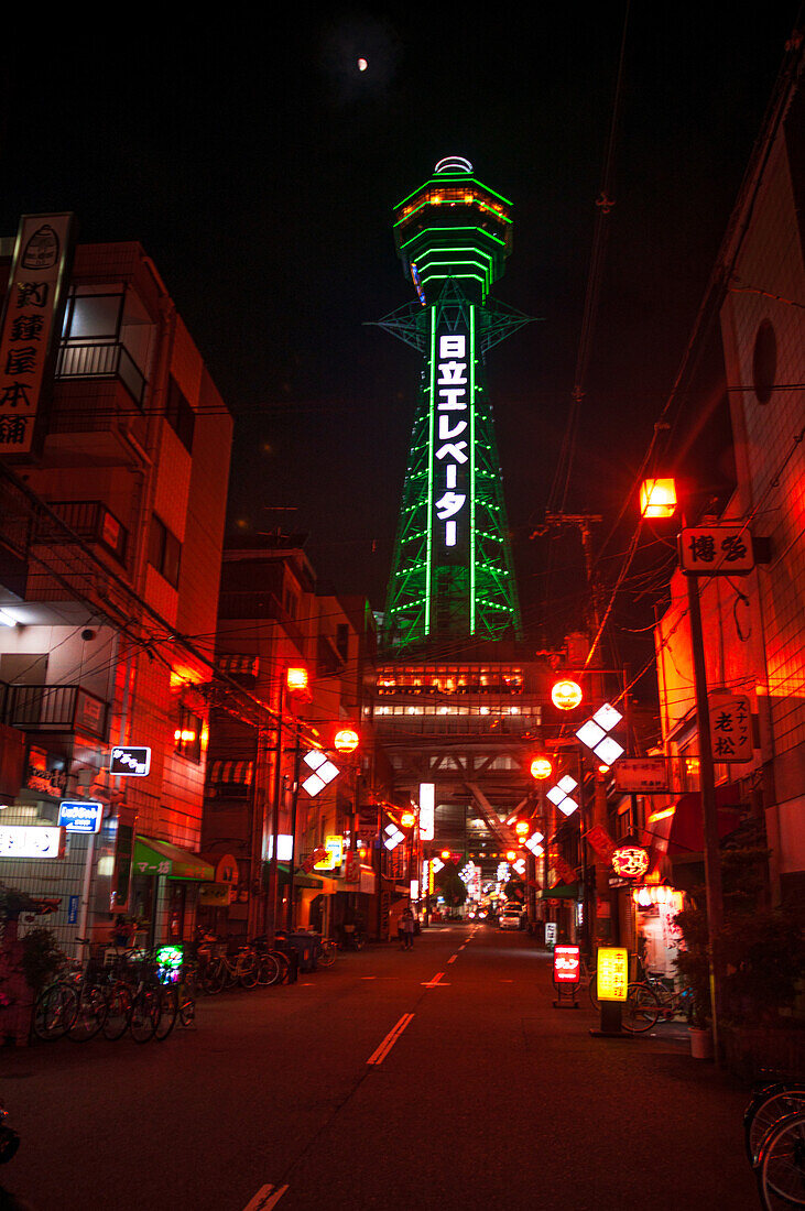 Night illumination of Shinsekai Tower in pitch black night, neon lights, Osaka, Honshu, Japan