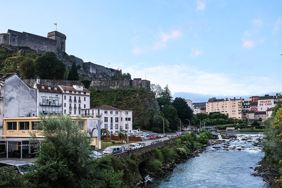 Urban landscape of Lourdes, market town in the Pyrenees, Chateau Fort in background, Lourdes, Hautes-Pyrenees, Occitanie, France