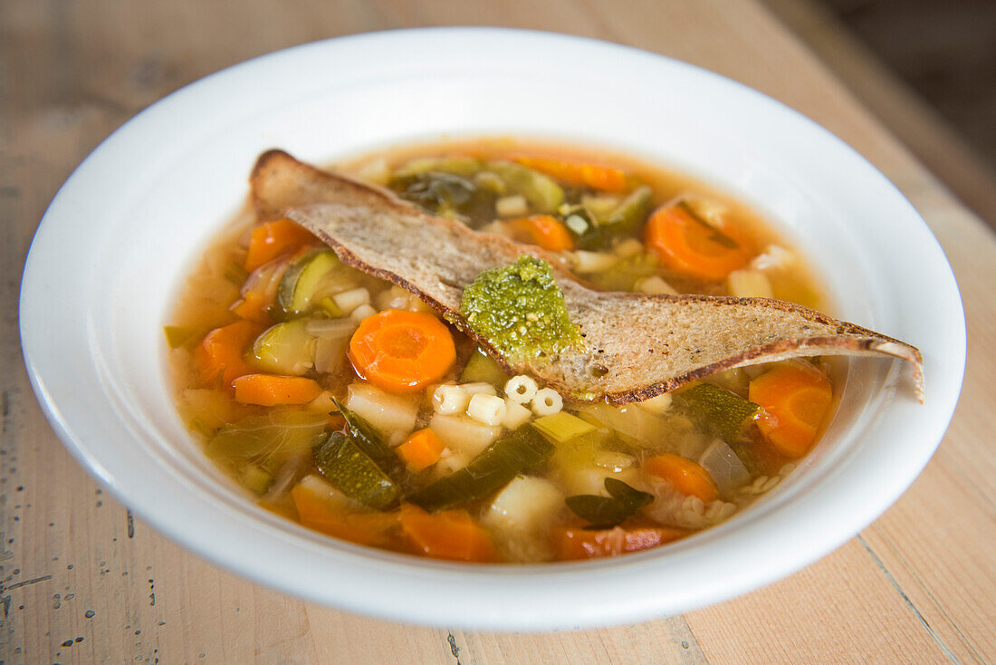 Minestrone soup at Mountain refuge Pian di Cengia (Bullelejochhutte), Three Peaks Nature Park, Dolomites, South Tyrol (Alto Adige), Italy