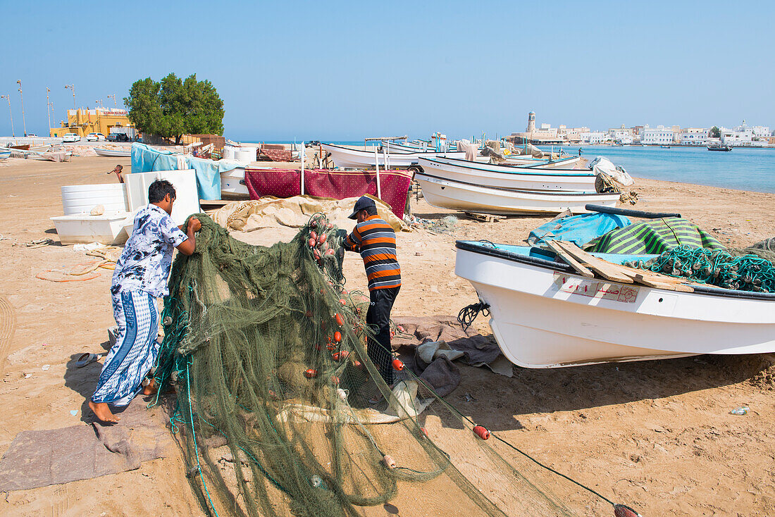 Fishermen on the beach in front of the Al Ayjah village, Sur, port-city, capital of Ash Sharqiyah Region, Sultanate of Oman, Arabian Peninsula