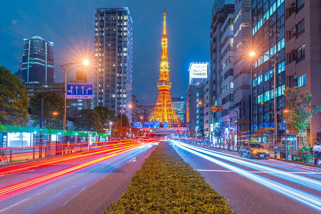 View of Tokyo Tower, city street and trail lights at night, Minato City, Tokyo, Honshu, Japan