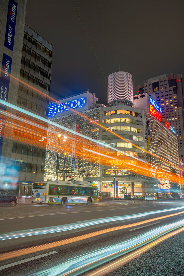 View of street scene, trail lights and shopping mall in Hiroshima at night, Hiroshima, Honshu, Japan