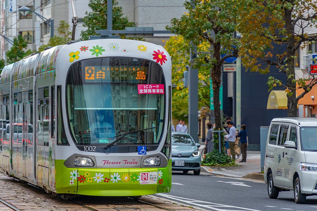 View of city tram on major street during daytime, Hondori, Naka Ward, Hiroshima, Honshu, Japan