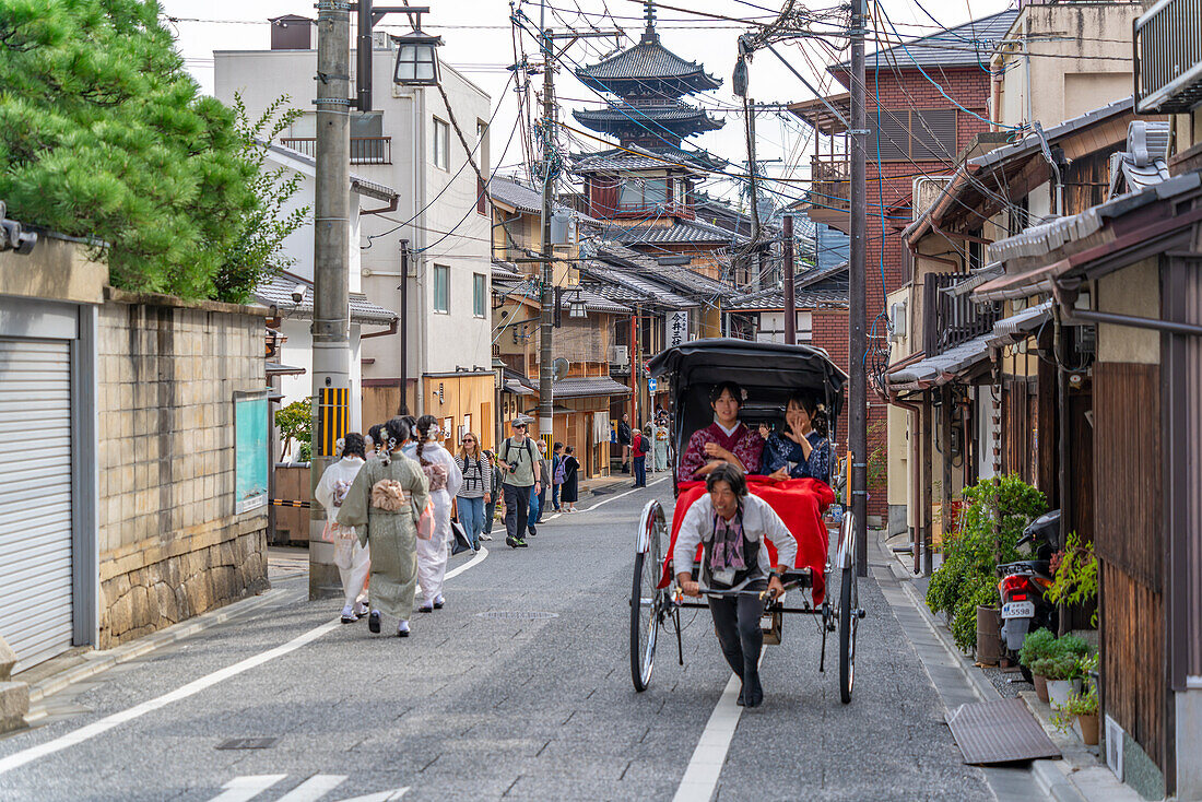 Blick auf Damen in Kimonos und Rikscha in Gion, Kyotoer Geisha-Viertel, Kyoto, Honshu, Japan