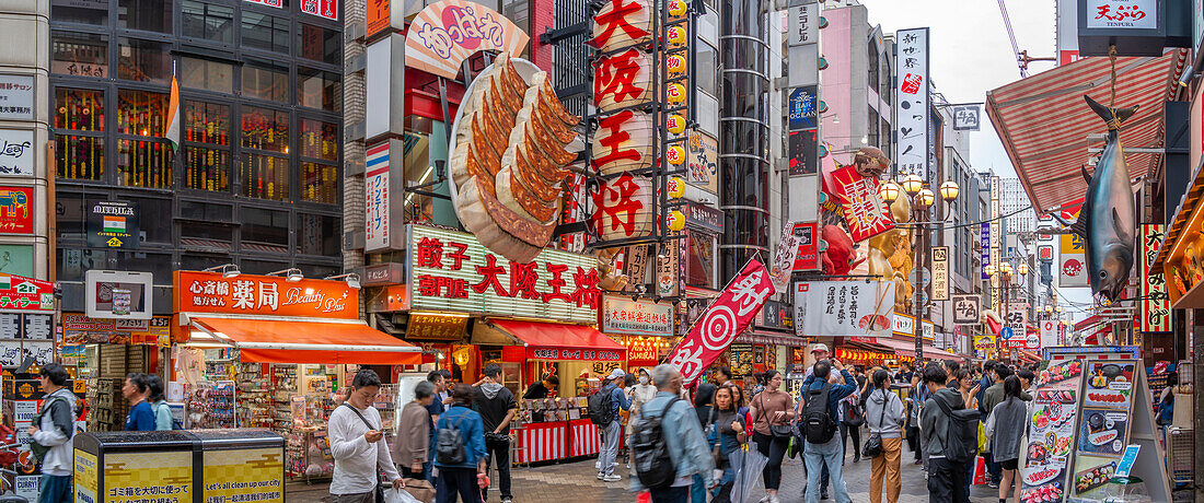 View of colourful signs of restaurants in Dotonbori, vibrant entertainment district near the river, Osaka, Honshu, Japan