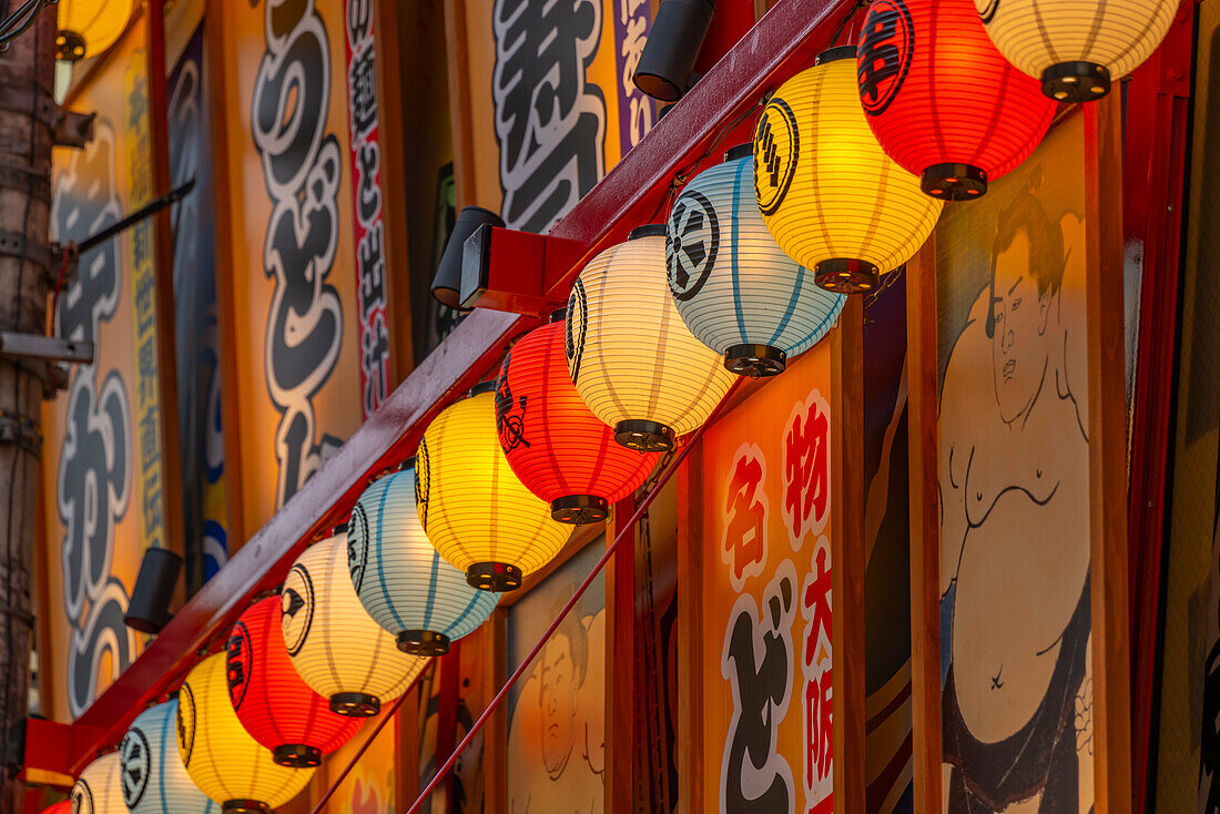 Blick auf bunte Fassaden von Geschäften und Restaurants in Dotonbori, pulsierendes Vergnügungsviertel in Flussnähe, Osaka, Honshu, Japan