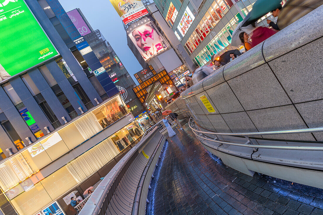 View of colourful adverts in Dotonbori, vibrant entertainment district near the river at dusk, Osaka, Honshu, Japan