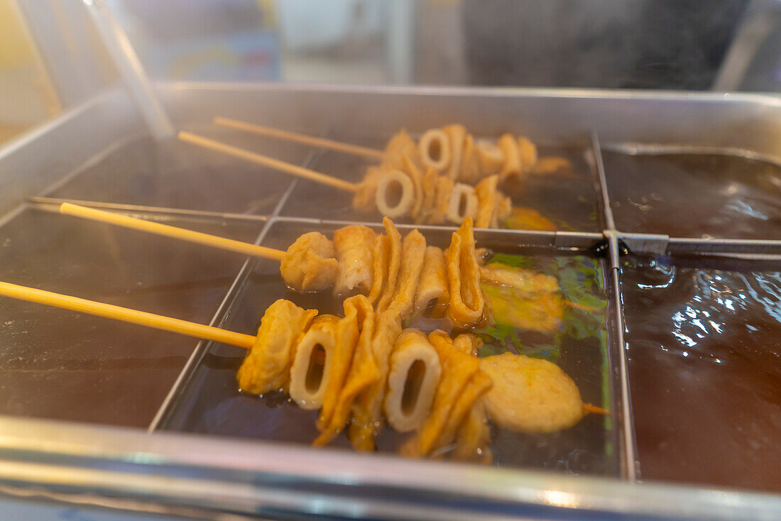 View of hot food stall in Dotonbori, vibrant entertainment district near the river, Osaka, Honshu, Japan