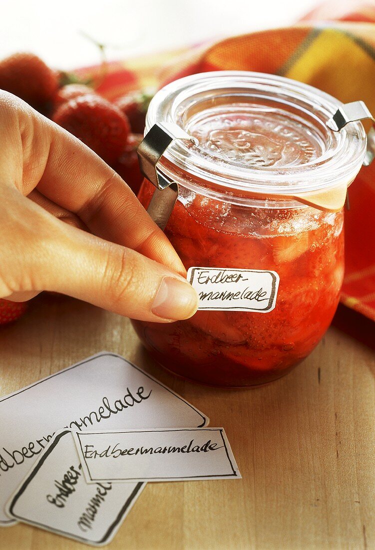 A jar of strawberry jam with label
