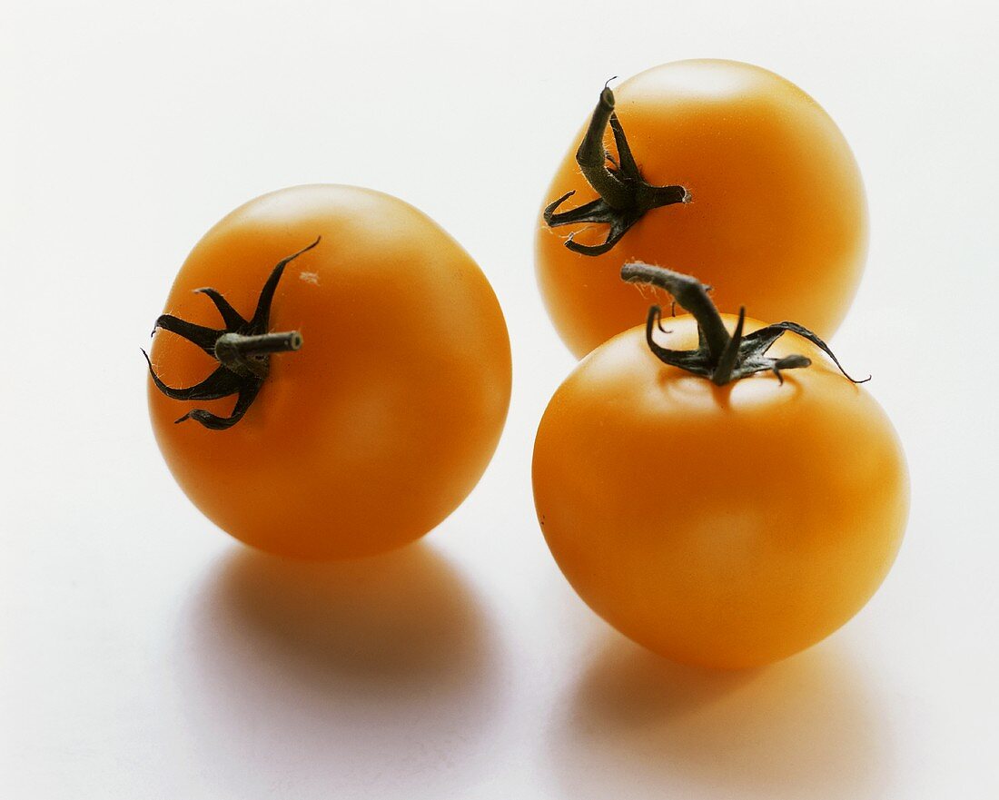 Three yellow tomatoes