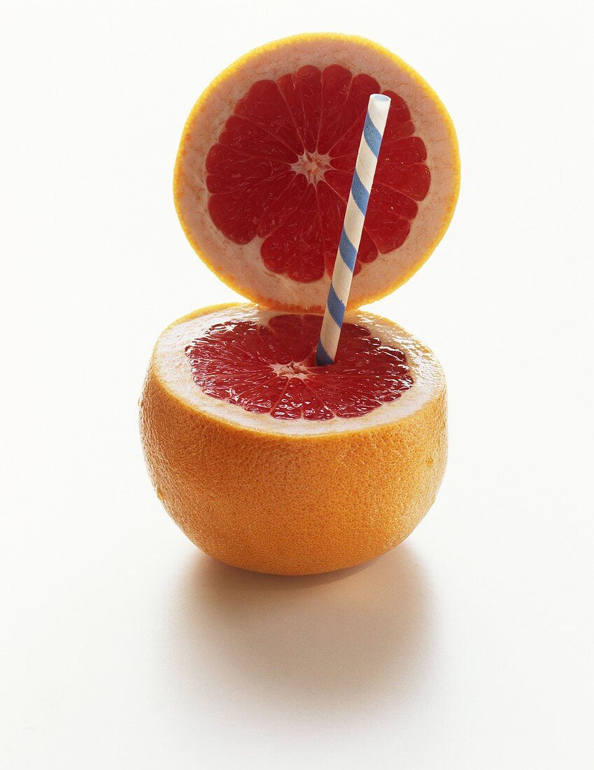 Red Grapefruit with Top Sliced and Straw Inserted