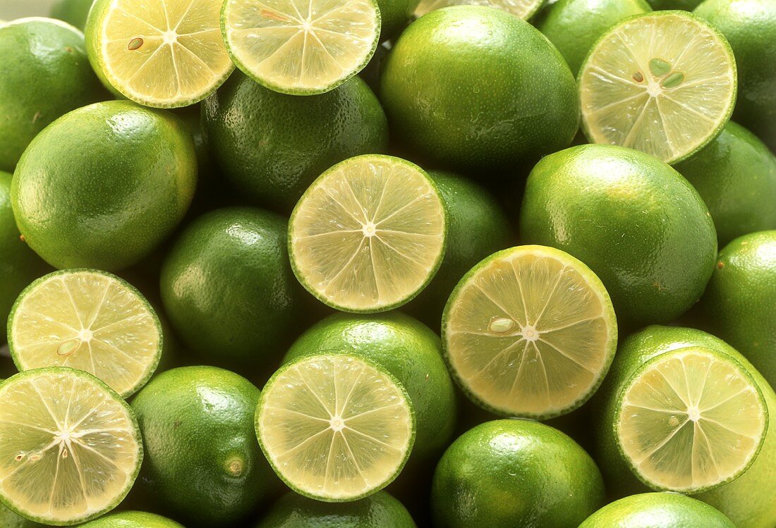 Limes and lime halves (filling the picture)