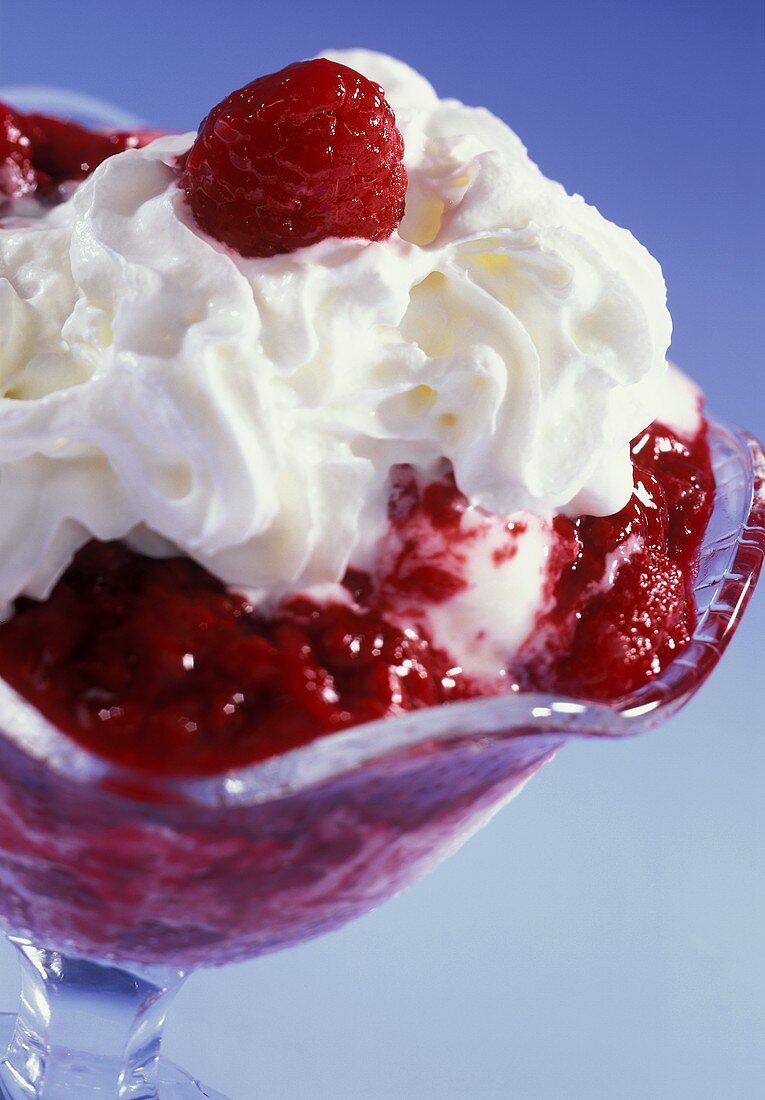 Vanilla ice cream sundae with hot raspberries & cream