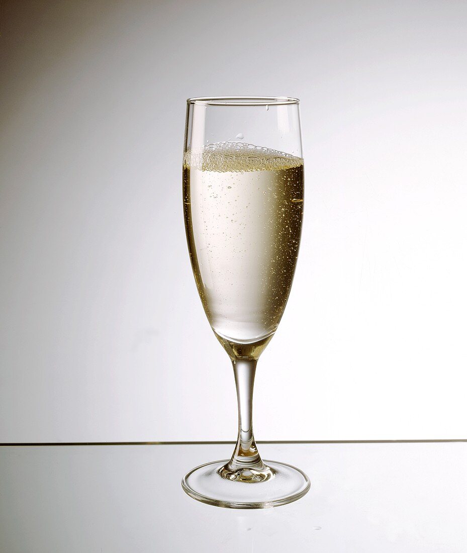 A glass of champagne on sheet of glass