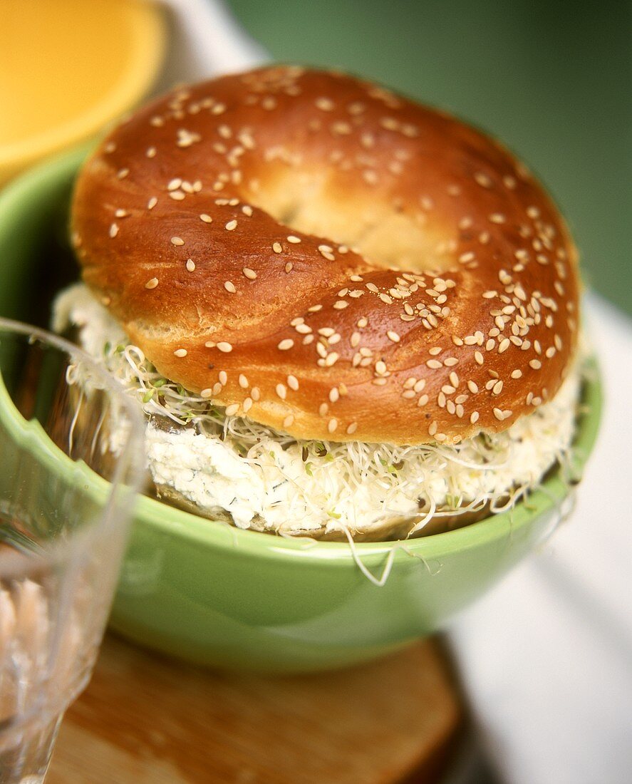 Sesame bagel with horseradish & cream cheese spread & sprouts