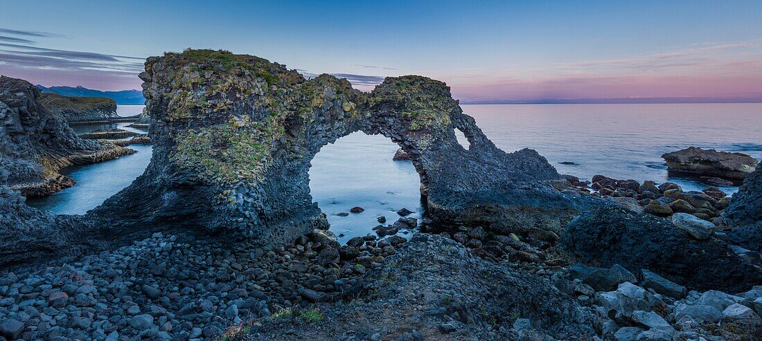 Iceland, Western Region, Grundafjordur, Arnarstapi, Gatklettur gate at sunset