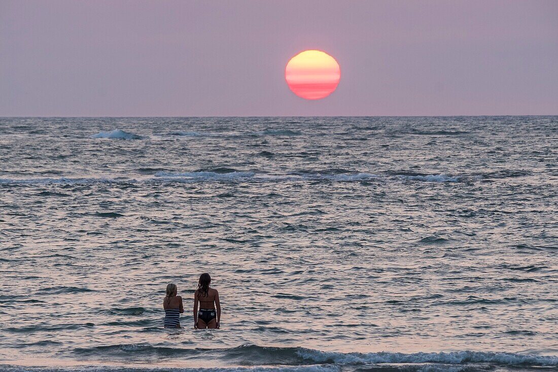 France, Charente Maritime, Oleron island, young women on the beach at sunset