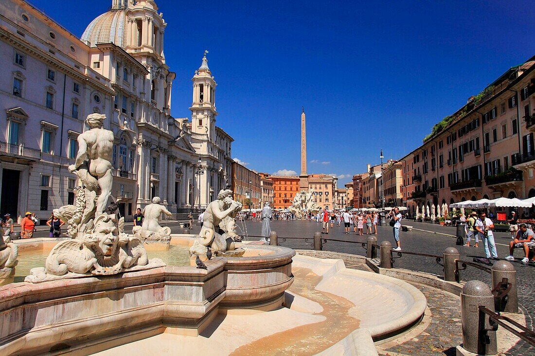 Italy, Lazio, Rome, UNESCO World Heritage Site, Piazza Navona, Fontana del Moro (Bernini's fountain) with Fontana dei Quattro Fiumi (Fountain of the Four Rivers) and Sant'Agnese Church in Agone ( Saint Agnes) in the background