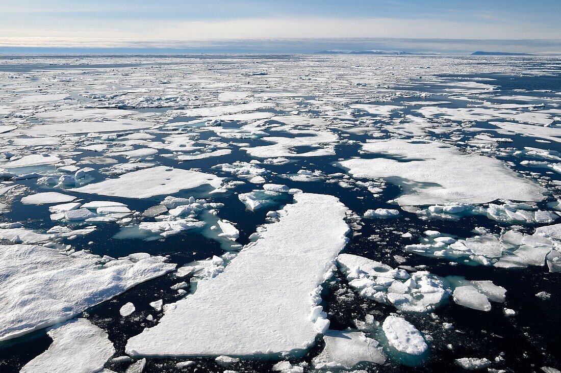 Greenland, North West coast, Smith sound north of Baffin Bay, broken pieces of Arctic sea ice and the Canadian coast of Ellesmere Island in the background