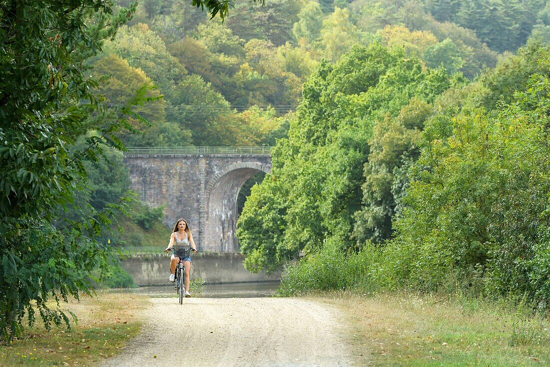 France, Ille et Vilaine, Guipry-Messac, bicycle in the wooded valley of Corbinières and the aqueduct ferrovière which crosses the Vilaine river