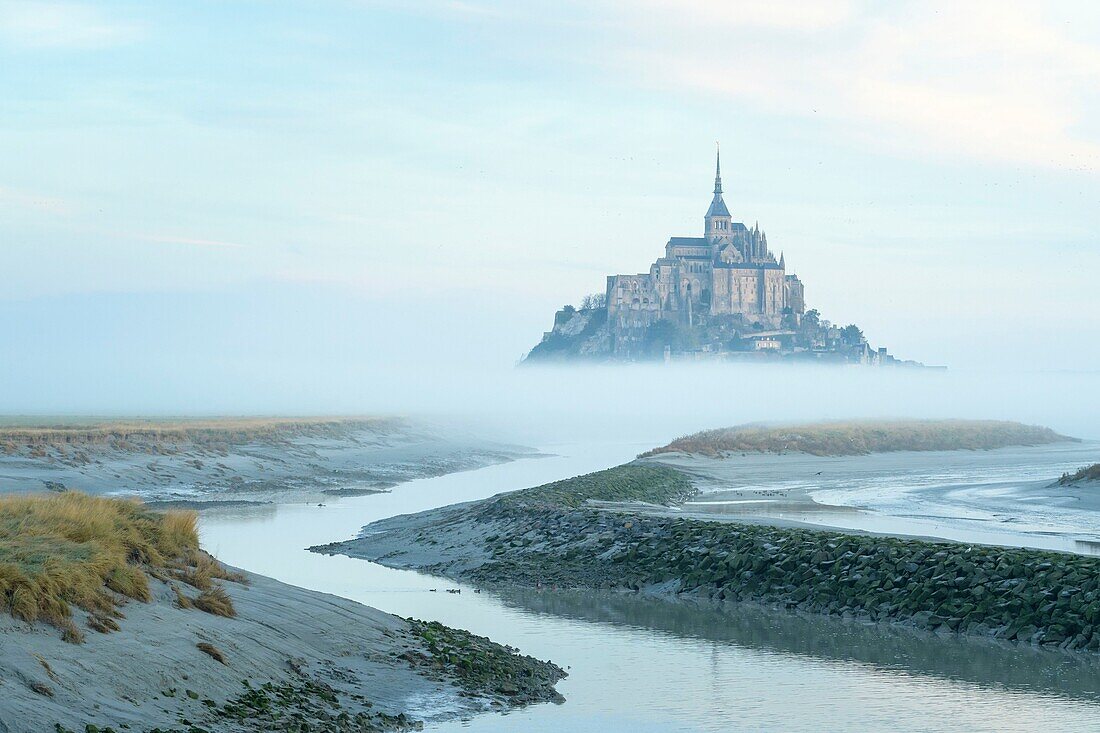 France, Manche, the Mont-Saint-Michel, view of the island and the abbey at sunrise from the mouth of the Couesnon river