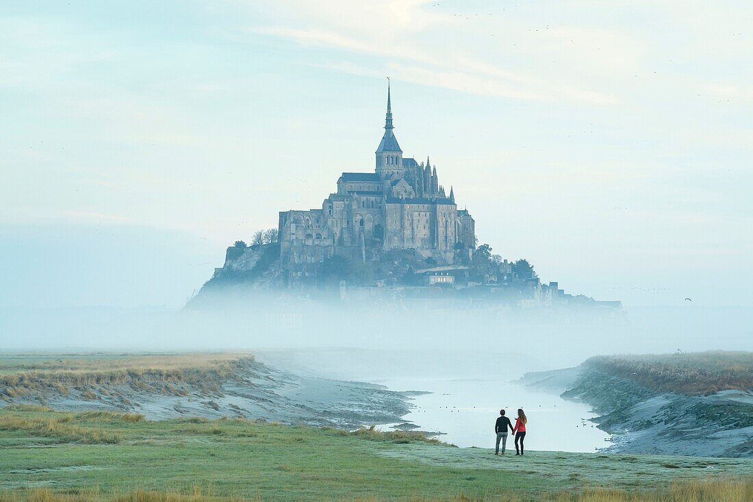 France, Manche, the Mont-Saint-Michel, view of the island and the abbey at sunrise from the mouth of the Couesnon river