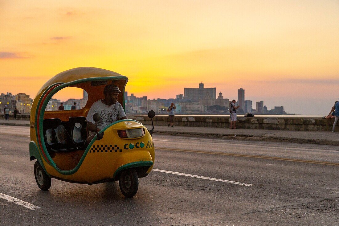 Kuba, Havanna, Stadtteil Habana Vieja, von der UNESCO zum Weltkulturerbe erklärt, Kokos-Taxi auf dem Malecon mit Hintergrund Vedado