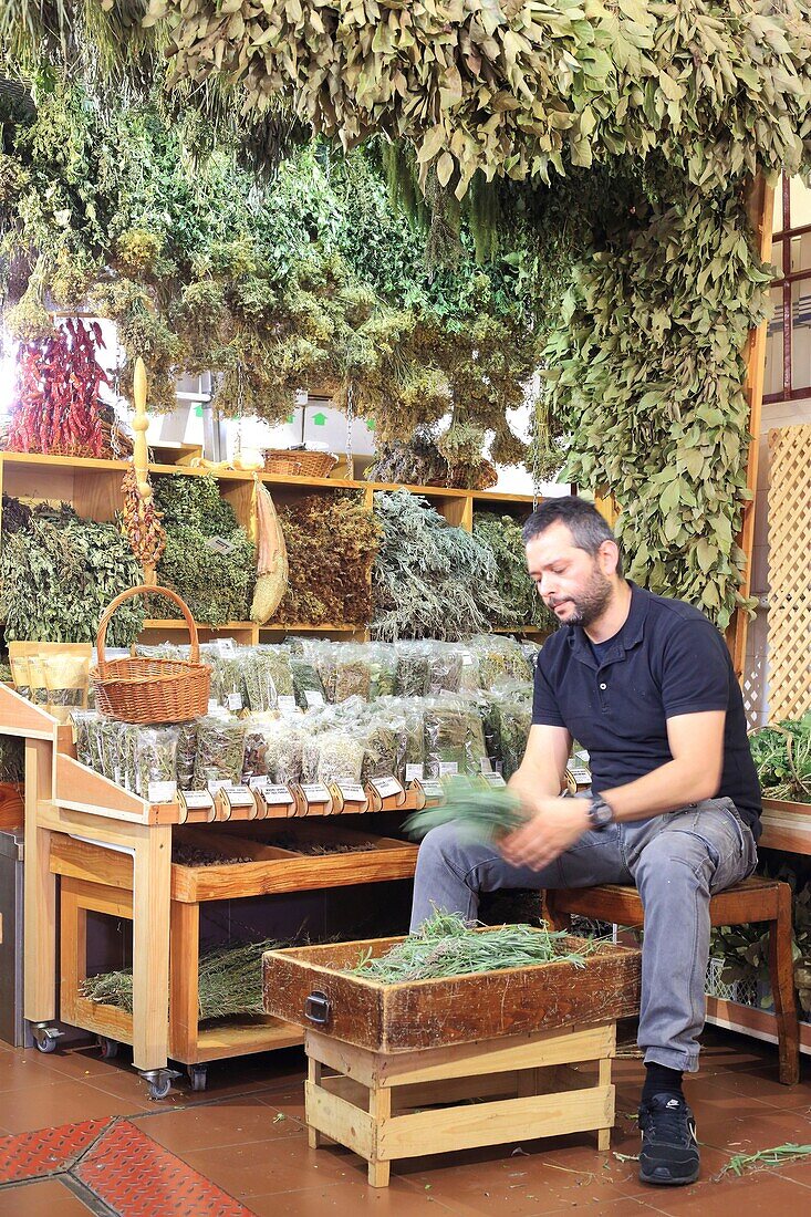 Portugal, Madeira Island, Funchal, market (Mercado dos Lavradores), seller of herbal teas and herbs