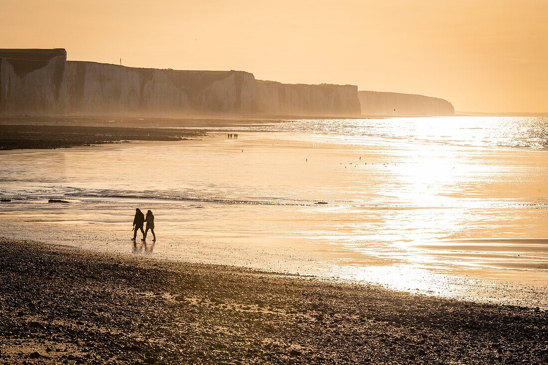 France, Somme, Bay of Somme, Picardy Coast, Ault, Walkers on beach at the foot of the cliffs