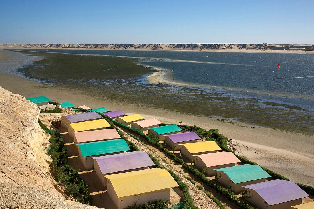 Morocco, Western Sahara, Dakhla, colorful roofs of the hotel PK25 facing the lagoon and the desert mountains