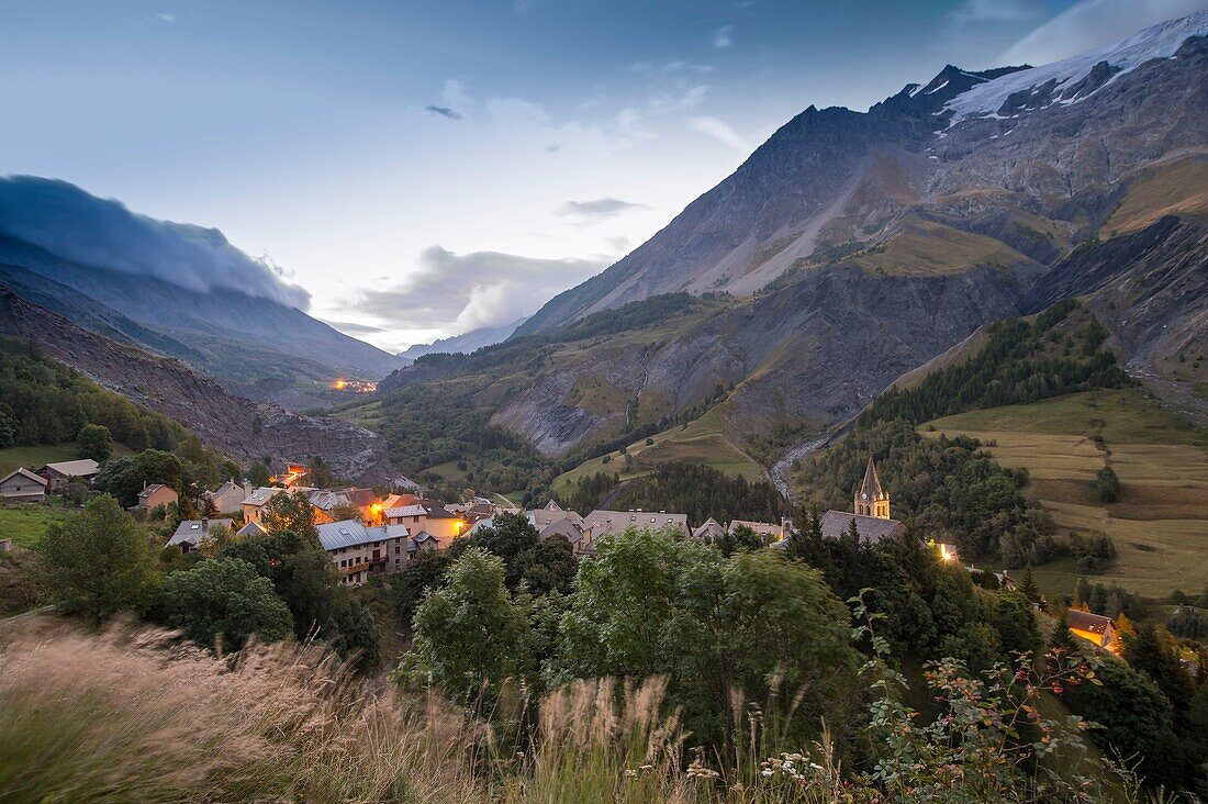 France, Hautes Alpes, The massive Grave of Oisans, the village at the foot of the Meije and its valleys in the crepuscule