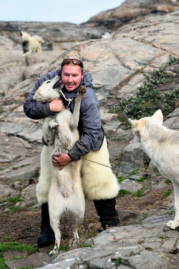 Greenland, West Coast, Uummannaq, the sled dog breeder Malti Suulutsun wearing bear skin trousers