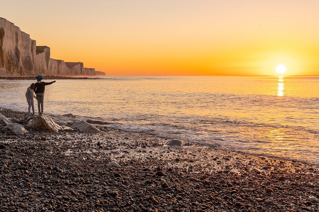 France, Somme, Picardy Coast, Ault, twilight at the foot of the cliffs that stretch towards Le Tréport and Normandy, children are playing on the rocks