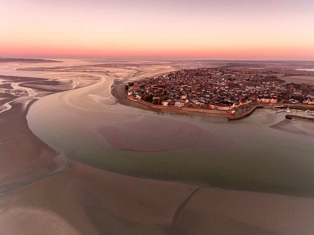 France, Somme, Baie de Somme, Le Crotoy, aerial view of the sunrise over the village of Crotoy and the slikke discovered by the low tide