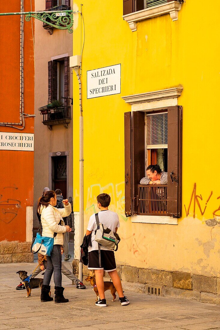 Italy, Veneto, Venice listed as World Heritage by UNESCO, venice inhabitants talking in the street