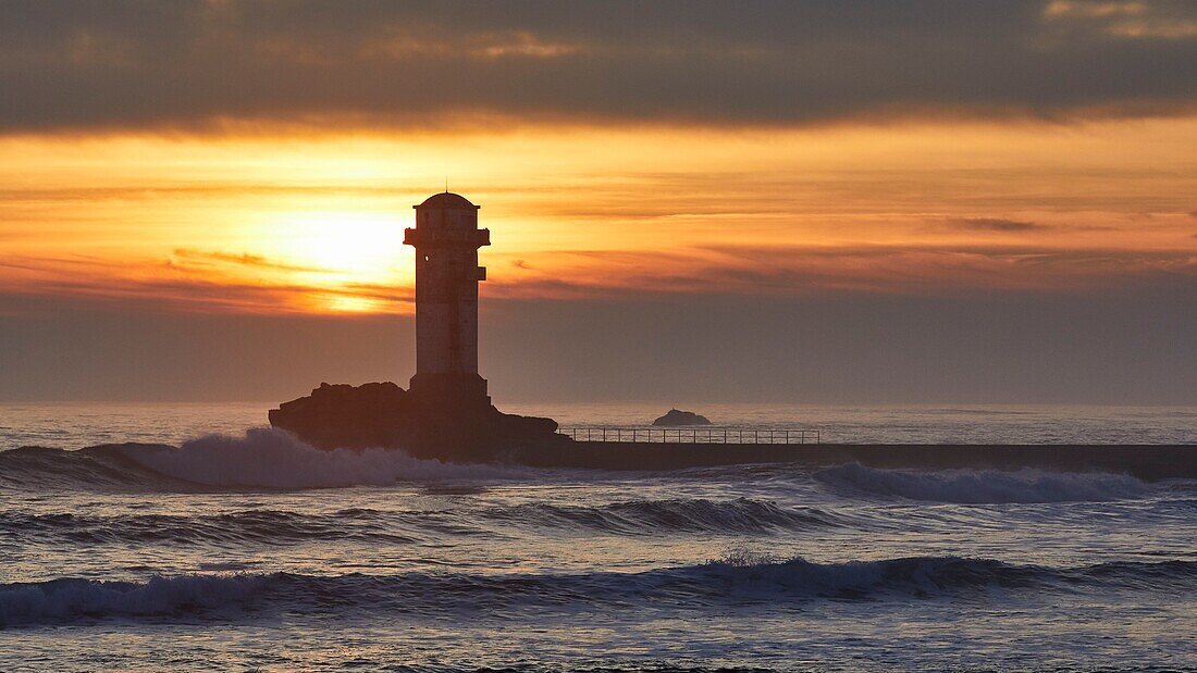 France, Finistere, Iroise Sea, Iles du Ponant, Parc Naturel Regional d'Armorique (Armorica Regional Natural Park), Ile de Sein, labelled Les Plus Beaux de France (The Most Beautiful Village of France), the Ar Gueveur lighthouse at sunset