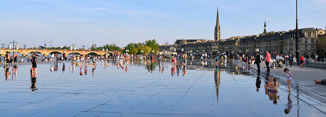 France, Gironde, Bordeaux, area listed as World Heritage by UNESCO, Saint Pierre district, Place de la Bourse, the reflecting pool from 2006 and directed by Jean-Max Llorca hydrant and Saint Michel basilica in the background