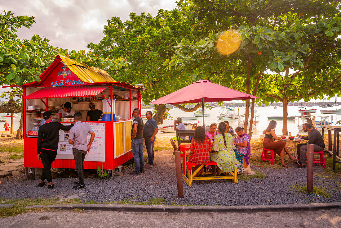 View of food stall in Grand Baie and boats in background, Grand Bay, Mauritius, Indian Ocean, Africa