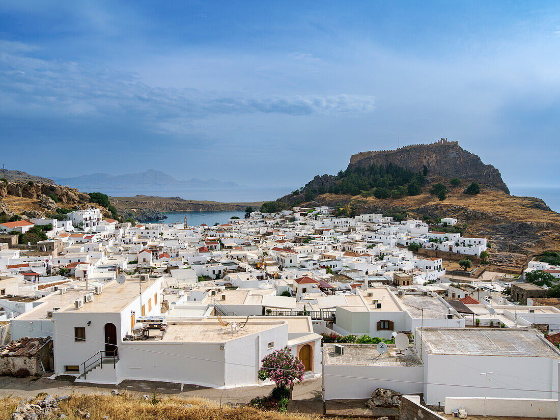 View over Lindos village towards the Acropolis, Rhodes Island, Dodecanese, Greek Islands, Greece, Europe