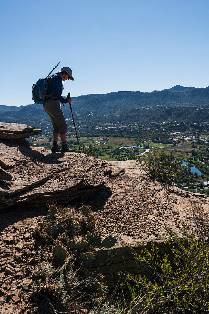 Usa, Colorado, Durango, Woman standing on ledge in San Juan Mountains