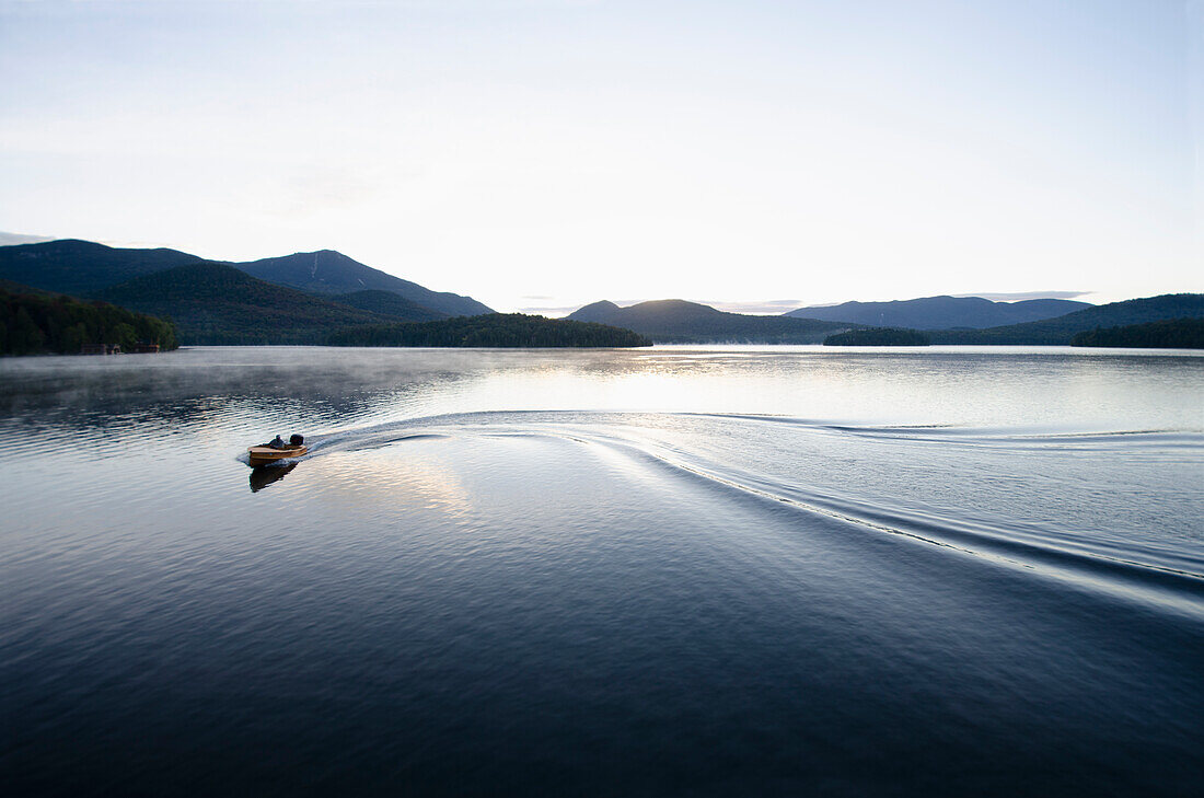 Boating at dawn on Lake Placid Lake, North Elba, New York, USA