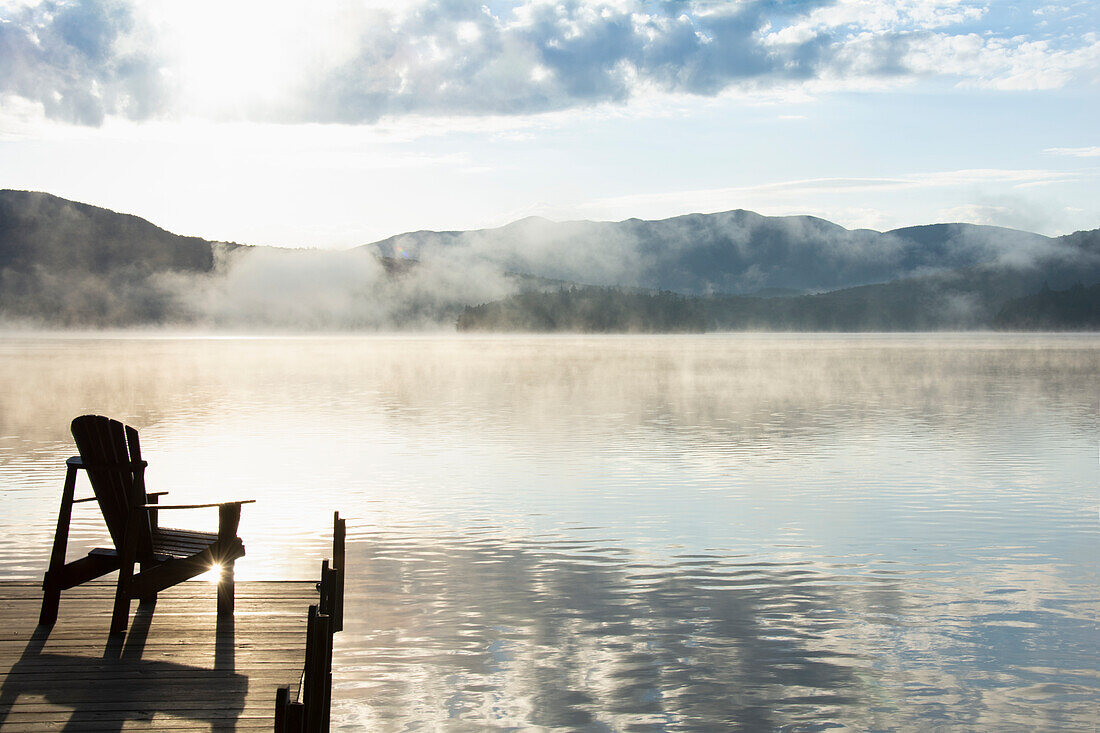 Boat dock at sunrise, Lake Placid, New York, USA