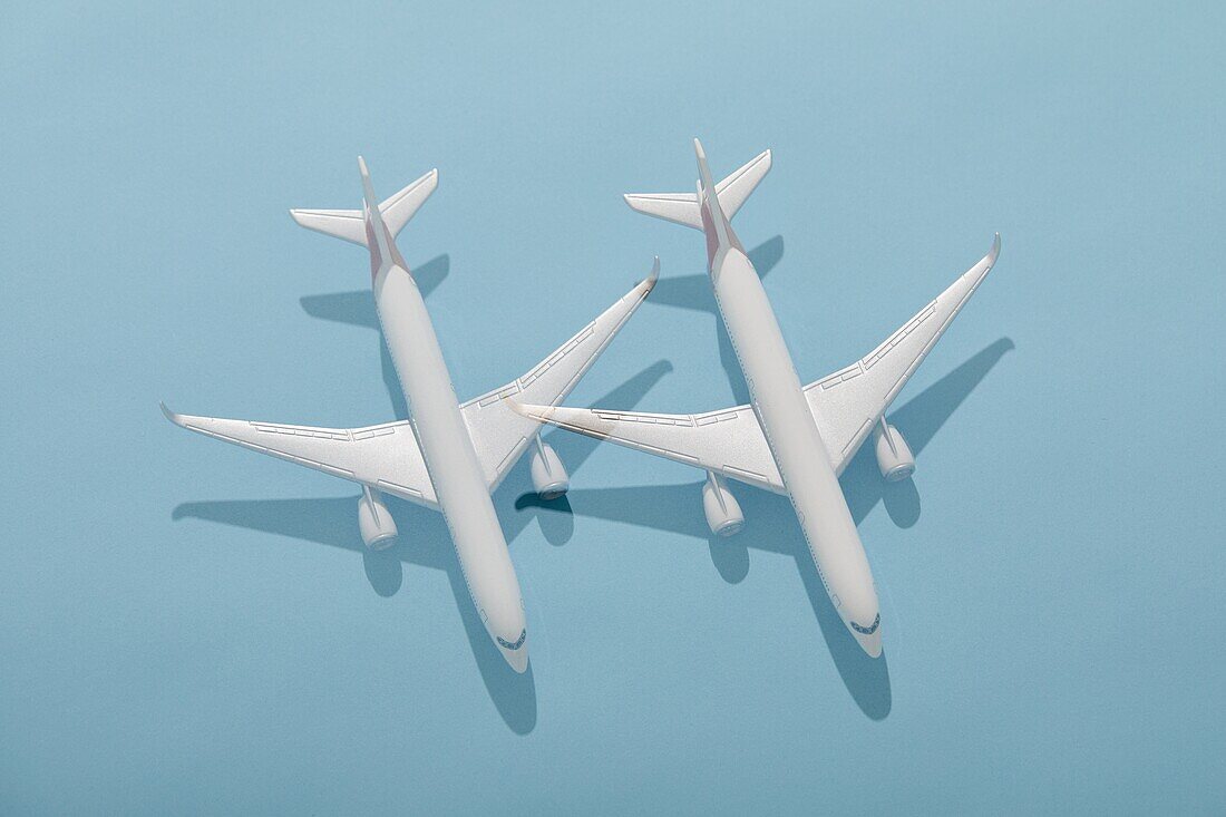 Overhead view of two model planes on blue background