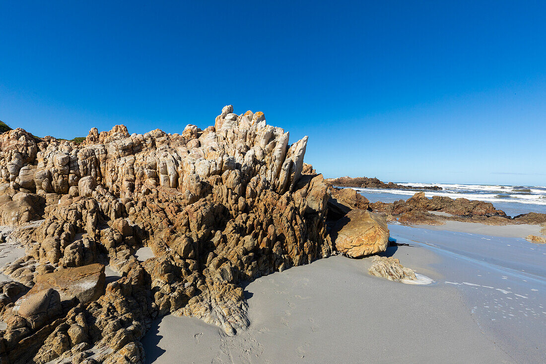 South Africa, Hermanus, Rocky coastline and sea at Voelklip Beach