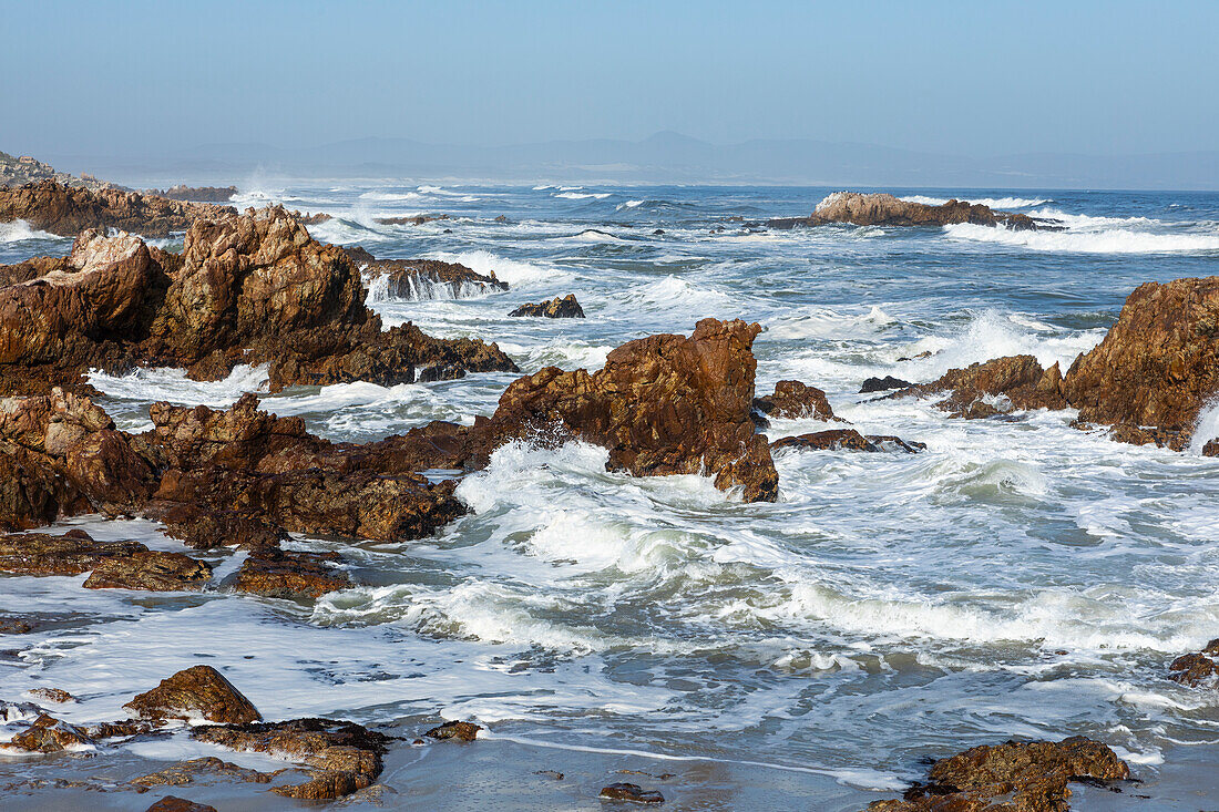 South Africa, Hermanus, Rocky coastline and sea at Kammabaai Beach