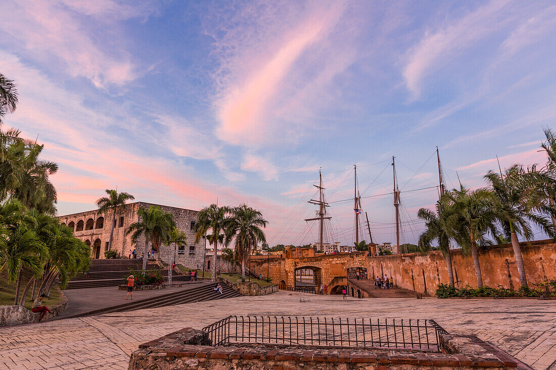 Alcazar de Colon or Columbus Palace in the Spanish Plaza, Colonial City of Santo Domingo, Dominican Republic. Built by governor Diego Columbus between 1510 and 1514. Puerta de Don Diego or Don Diego Gate at center. UNESCO World Heritage Site of the Colonial City of Santo Domingo. In the background is a sailing ship at dock.