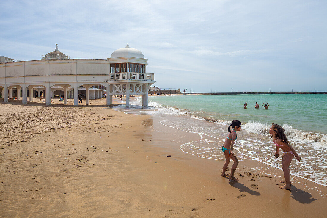 Children playing at La Caleta beach, Cadiz, Spain