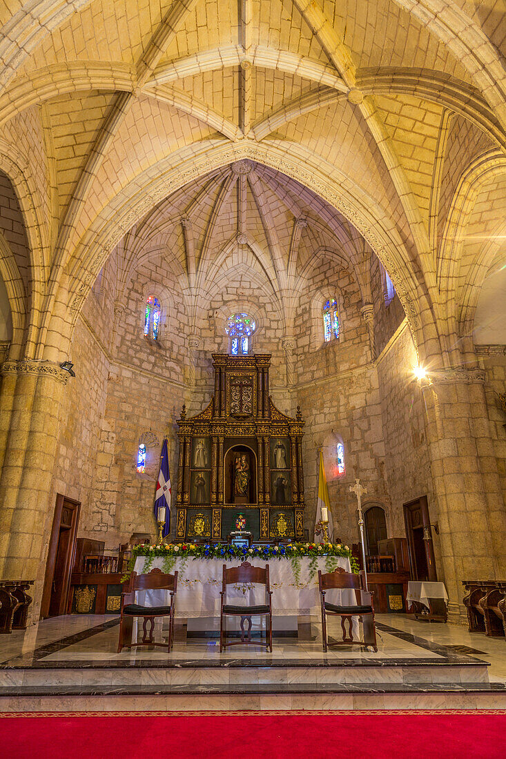 The altar & main altarpiece in the Cathedral of Santo Domingo in colonial Santo Domingo, Dominican Republic. The Cathedral of Santa Maria La Menor was the first cathedral built in the Americas, completed about 1540 A.D. It is a Minor Basilica and is located in the old Colonial City of Santo Domingo. UNESCO World Heritage Site of the Colonial City of Santo Domingo.