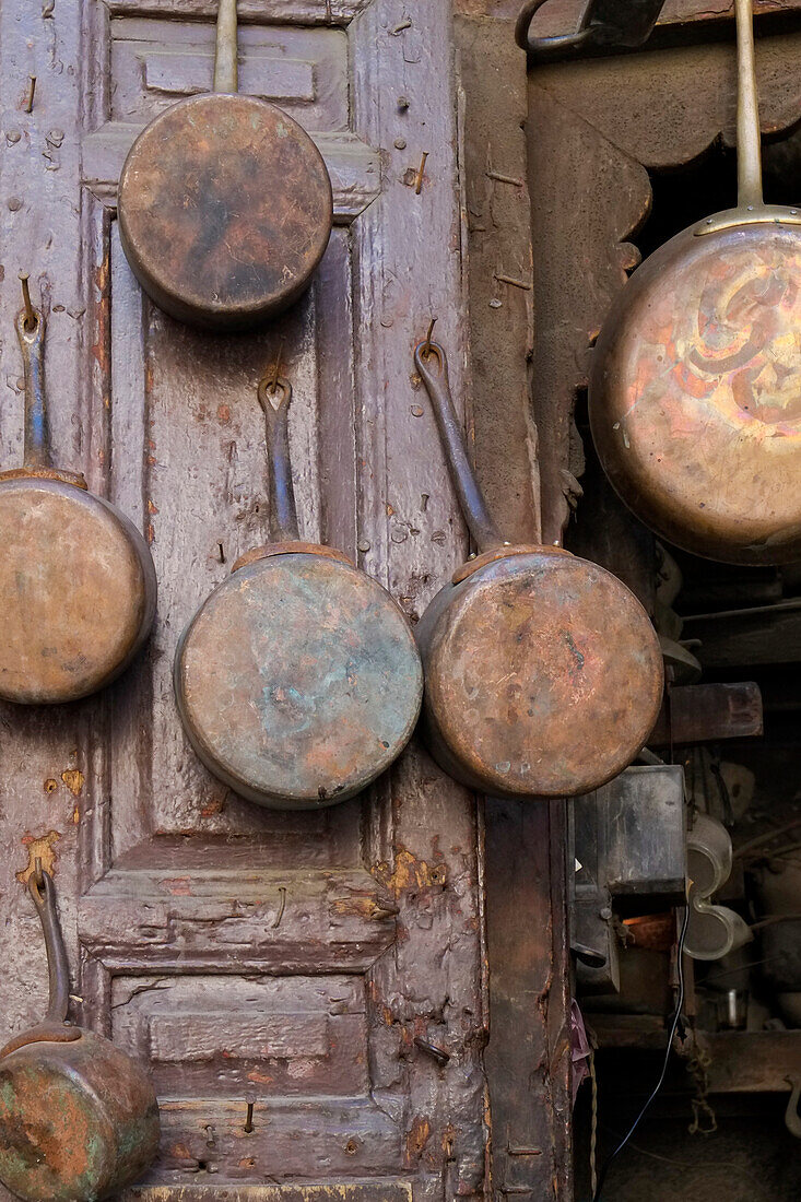 Fes, Morocco. Antique copper pans for sale in the medina